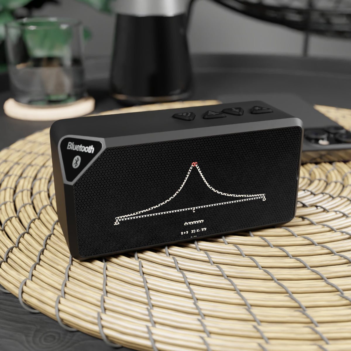 Black resonance curve speaker on a woven placemat